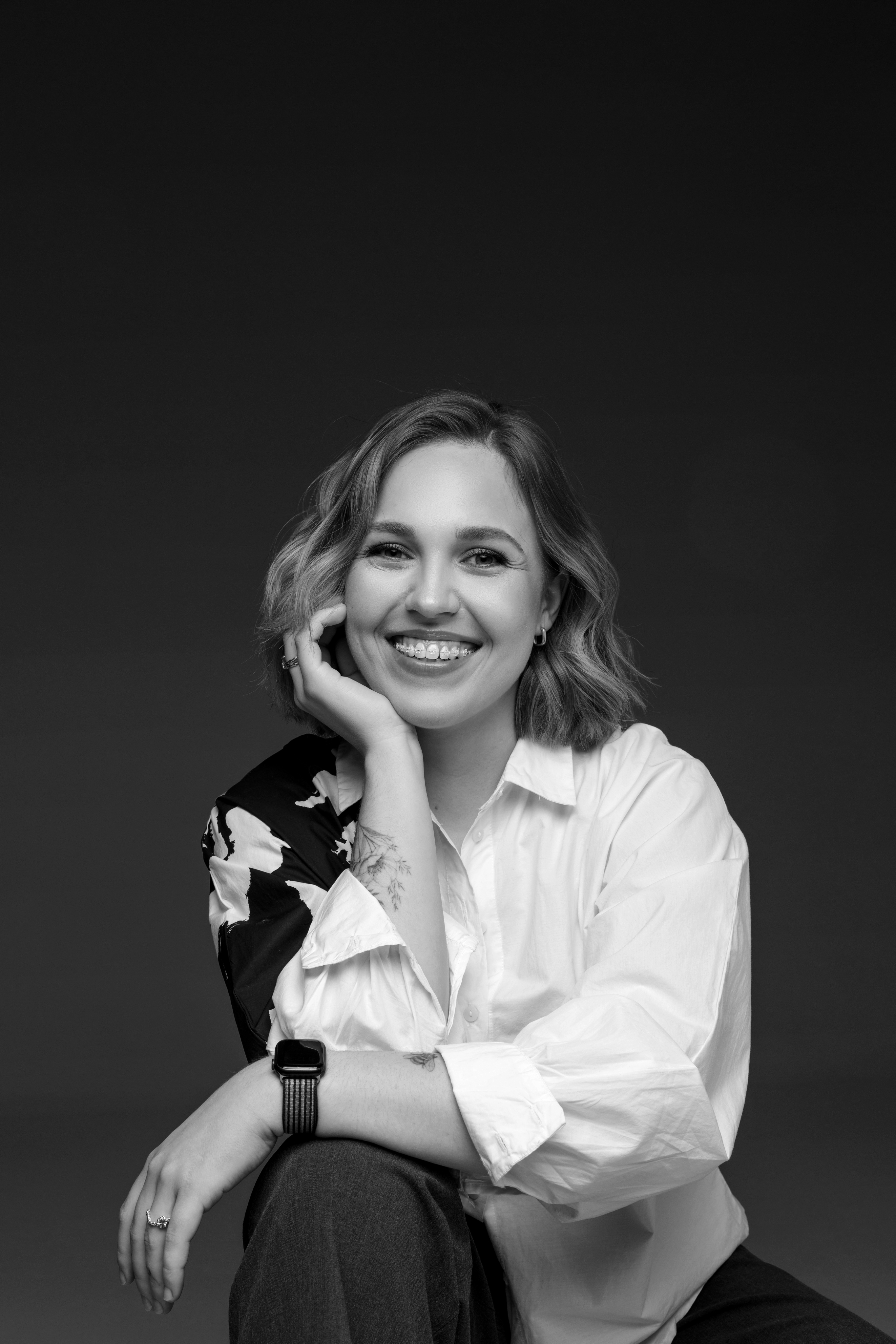 Black and white photo of Yuliia Kucherenko sitting and smiling